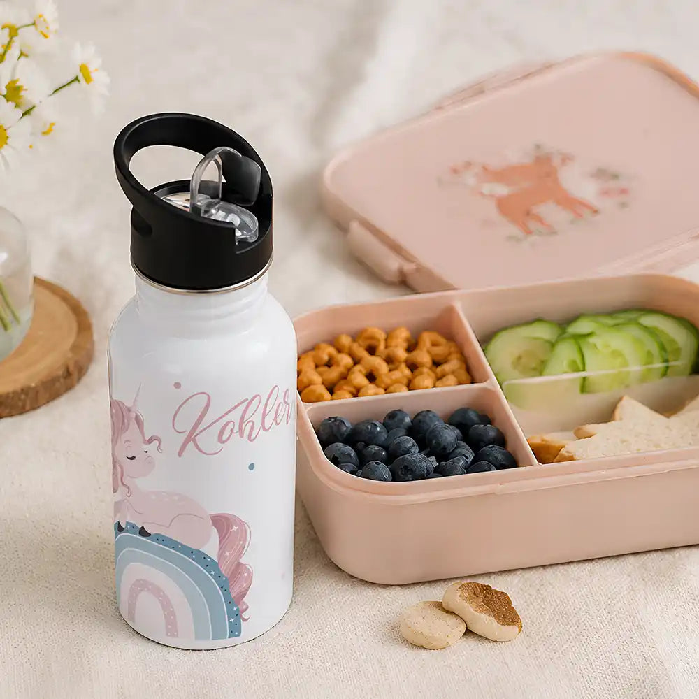 Gourde personnalisée motif Licorne sur arc-en-ciel à côté d'une boîte à goûter — Kidsmood